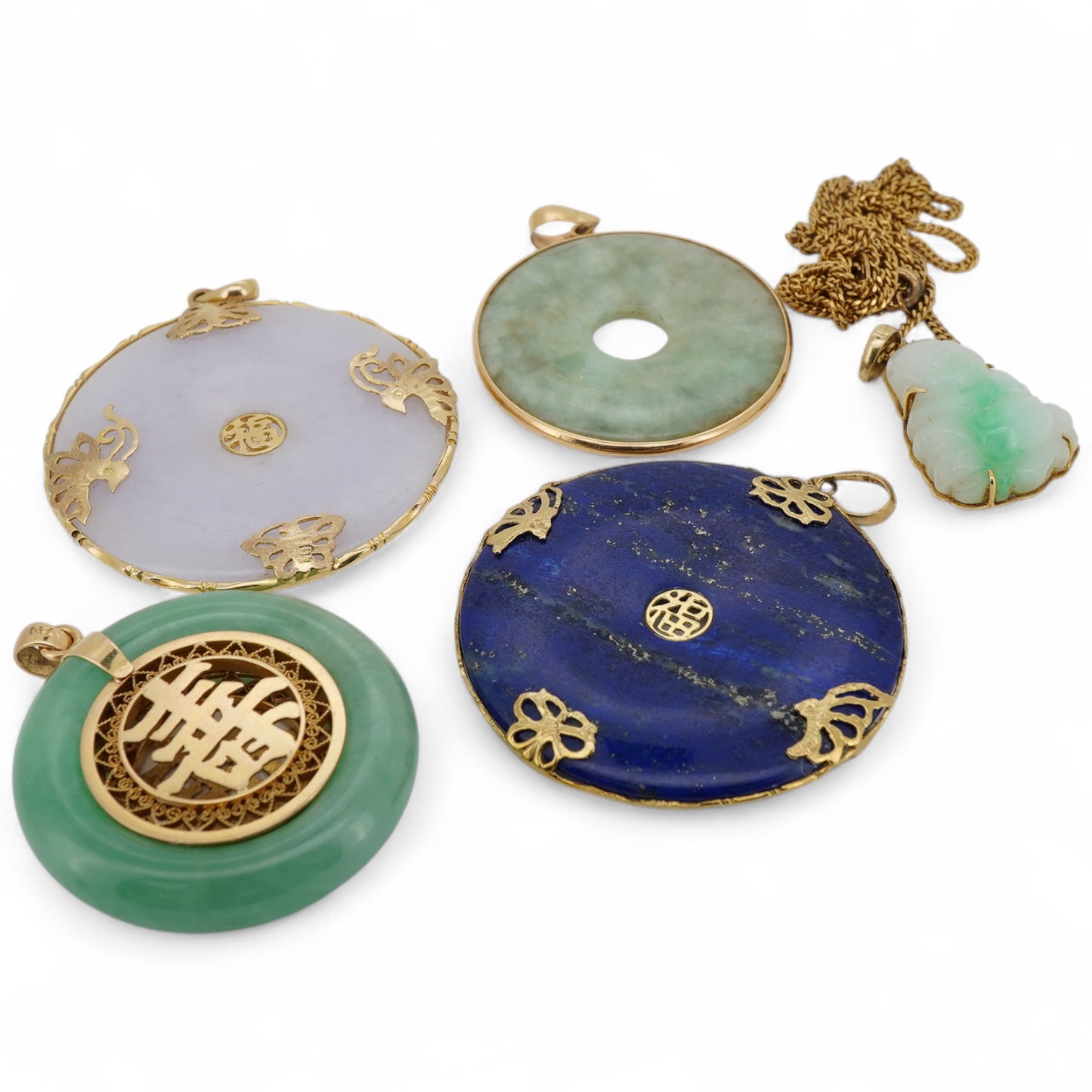 A collection of Chinese jewels, including three disc shaped pendants in pale lavender and green jadeite, mounted in gold, longest 4.6cm including bail; another disc-shaped pendant in lapis lazuli, mounted in gold; and a